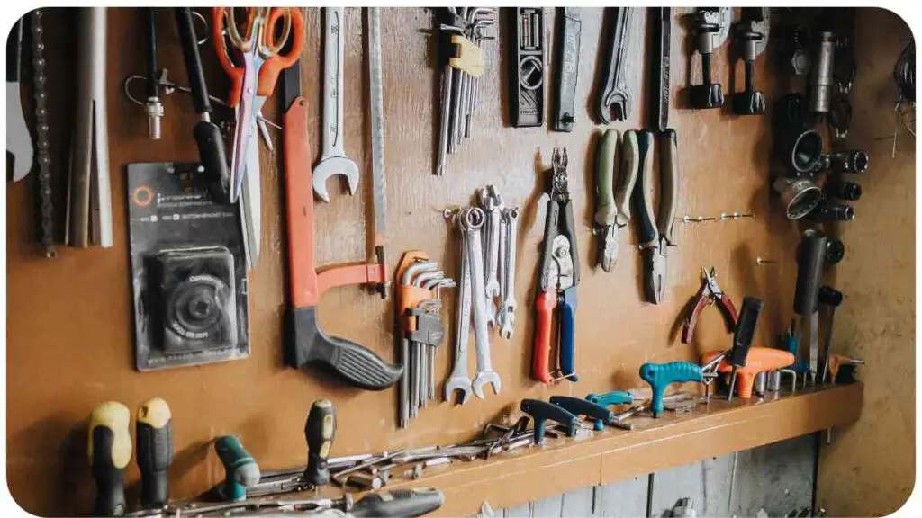 many tools are hanging on a wall in a workshop